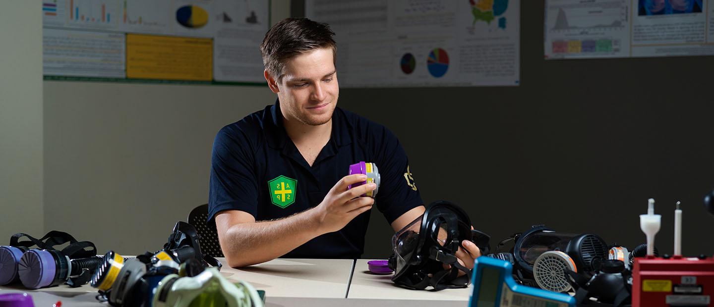 Ryan Papiernik working with environmental health and safety devices in a classroom